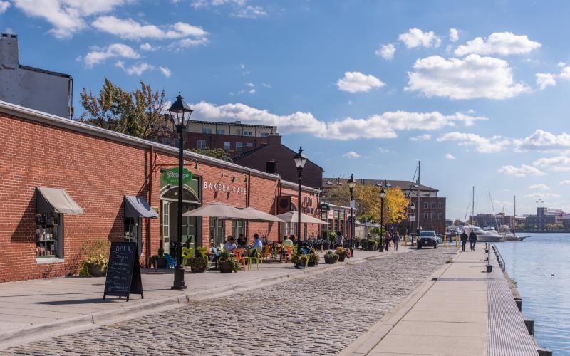 a brick walkway with buildings along it