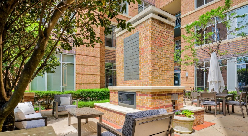 a patio with chairs and tables